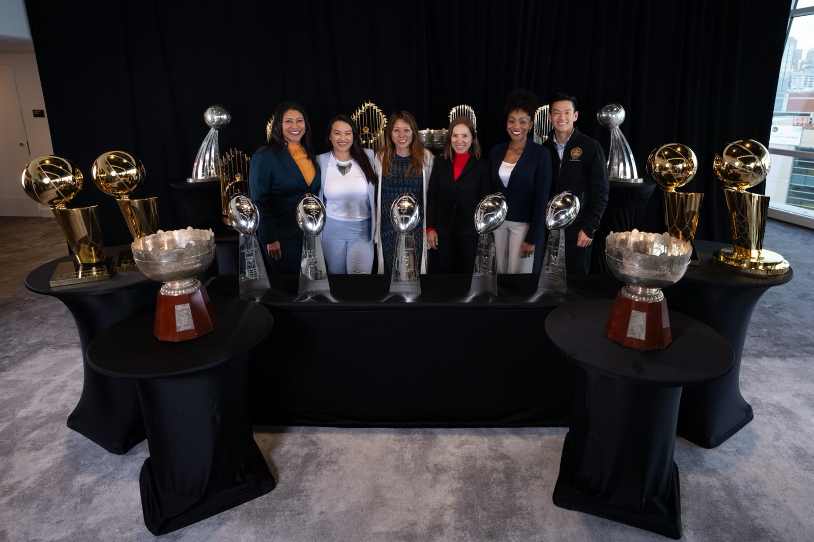 Image of Elected Officials with Professional Sports Trophies 