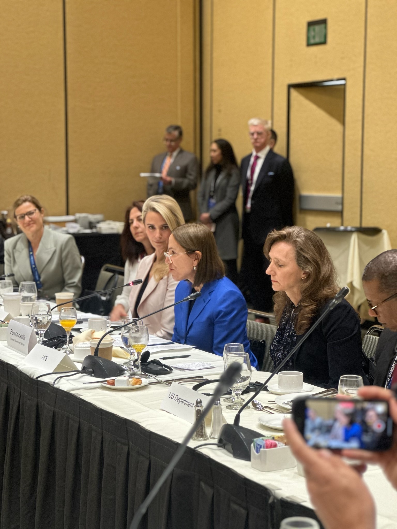 Image of Lt. Gov. Kounalakis speaking at a table with First Partner Siebel Newsom and other dignitaries at the APEC Summit. 