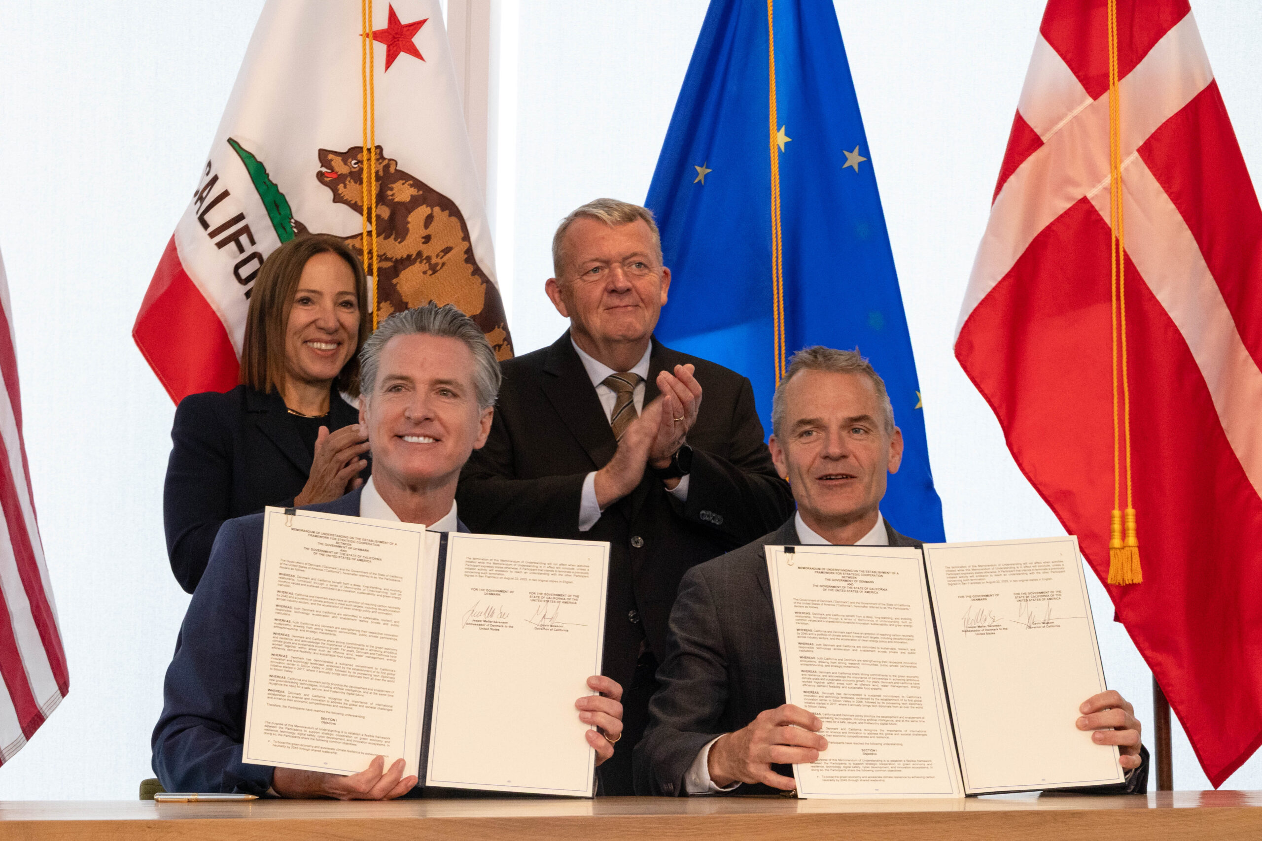 Image of Lt. Governor Kounalakis, Governor Newsom, and dignitaries from Denmark to sign a climate agreement