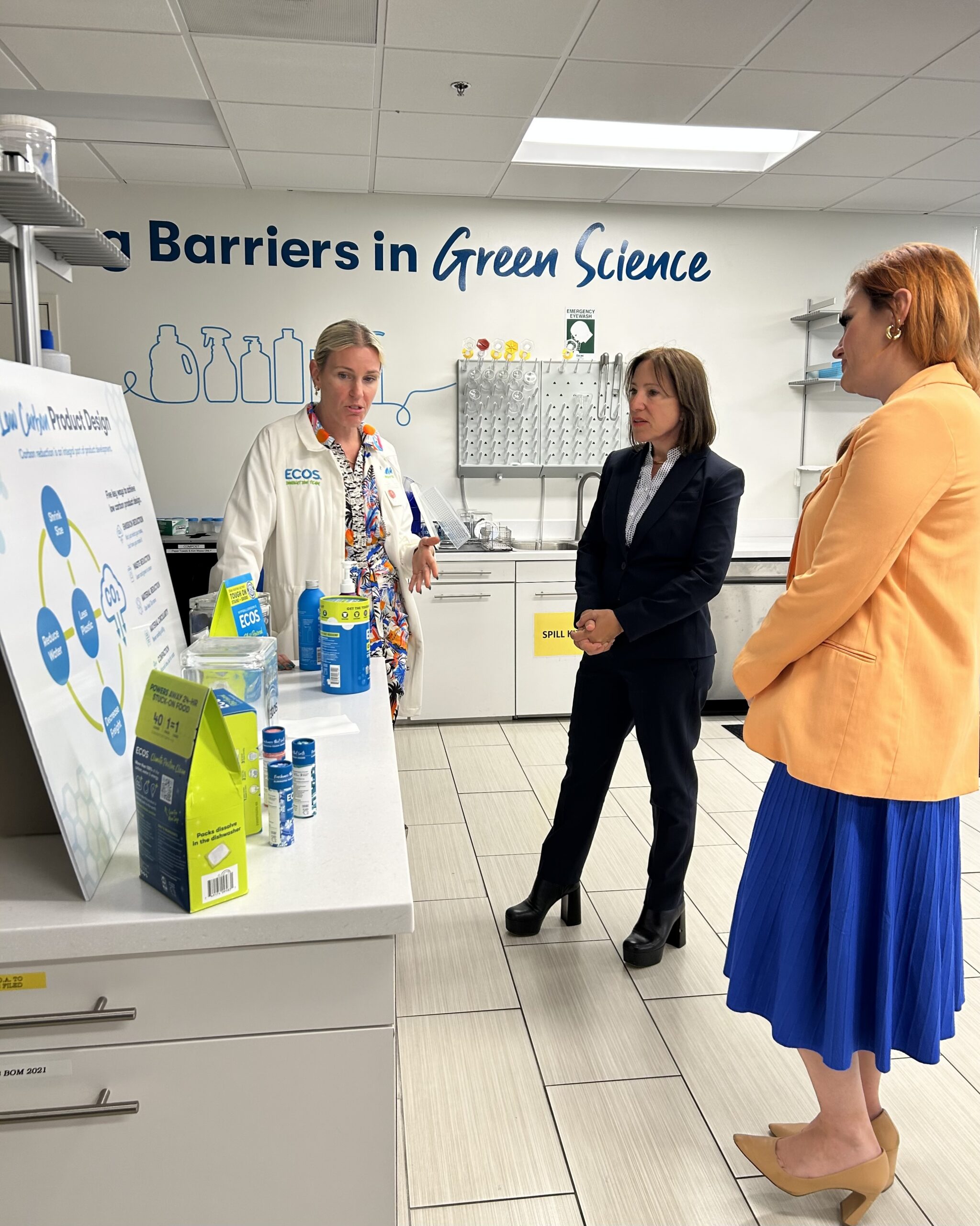 Image of Lt. Gov. Kounalakis at ECOS speaking with ECOS staff members and looking at ECOS products.