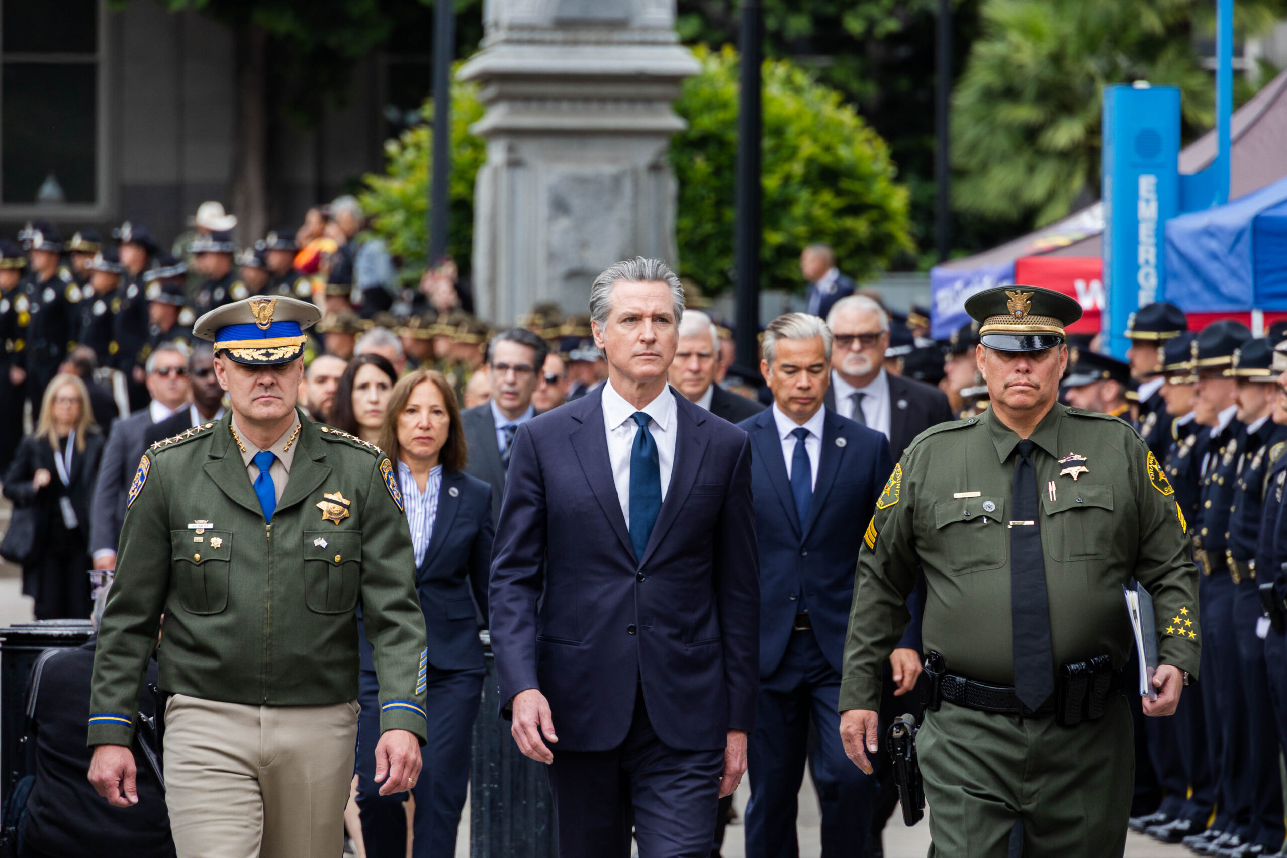 Image of Governor Newsom, Lt. Gov. Kounalakis and Police Officers walking